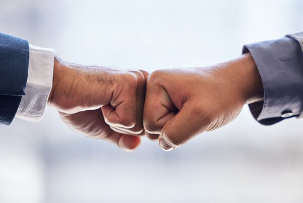 Two people fistbumping