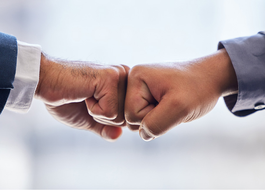 Two people fistbumping